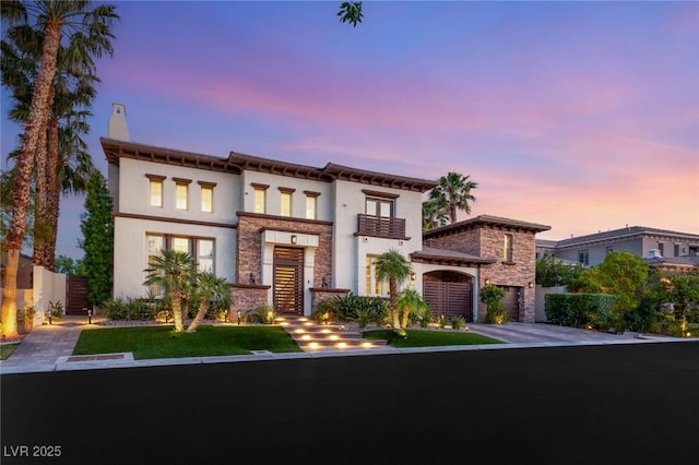 10301 Orkiney Dr, Las Vegas, NV 89144 - view of front of house with stone siding, stucco siding, driveway, an attached garage, and a chimney