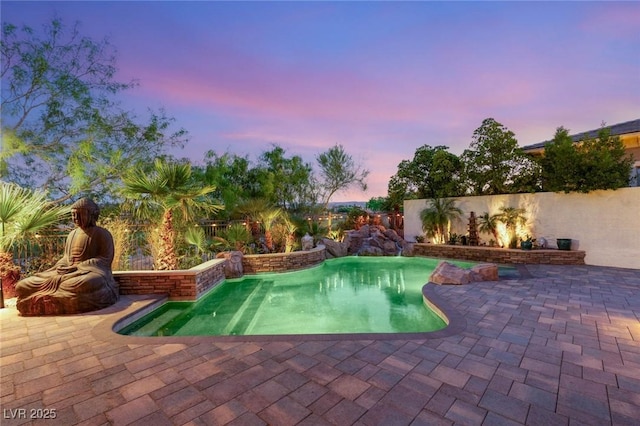 10301 Orkiney Dr, Las Vegas, NV 89144 - pool at dusk featuring a patio and a fenced backyard