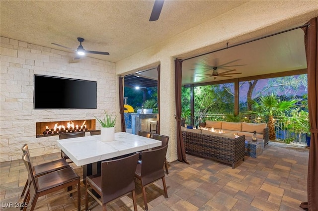 10301 Orkiney Dr, Las Vegas, NV 89144 - view of patio with a ceiling fan, an outdoor living space with a fireplace, and outdoor dining space