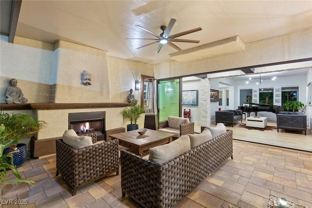 10301 Orkiney Dr, Las Vegas, NV 89144 - view of patio with an outdoor living space with a fireplace and ceiling fan