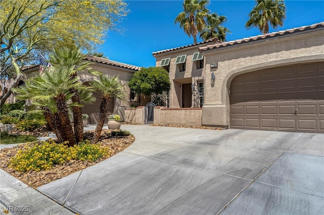 7206 Laramie Ave, Las Vegas, NV 89113 - mediterranean / spanish-style house featuring concrete driveway, stucco siding, a garage, and a tiled roof