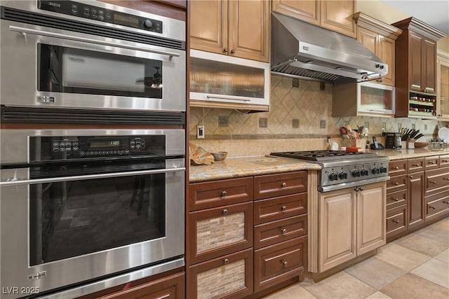 7206 Laramie Ave, Las Vegas, NV 89113 - kitchen featuring stainless steel appliances, under cabinet range hood, decorative backsplash, and light stone counters