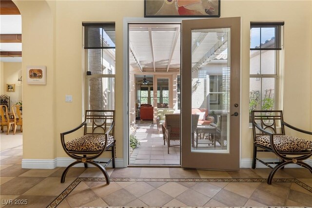 7206 Laramie Ave, Las Vegas, NV 89113 - doorway to outside featuring plenty of natural light, ceiling fan, baseboards, and tile patterned floors