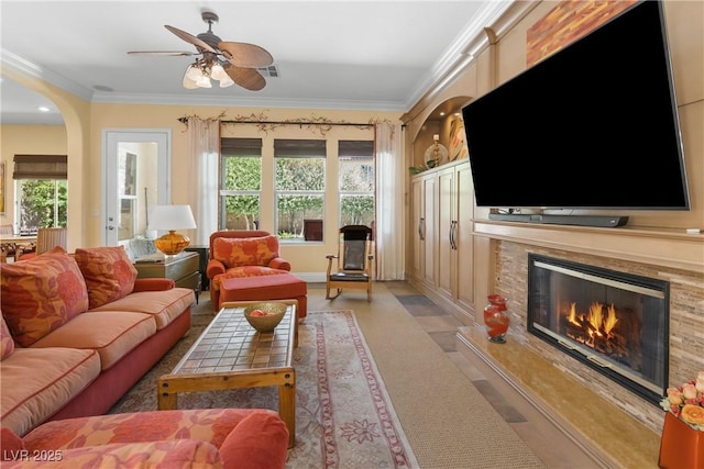 7206 Laramie Ave, Las Vegas, NV 89113 - living area featuring crown molding, plenty of natural light, a fireplace, a ceiling fan, and arched walkways