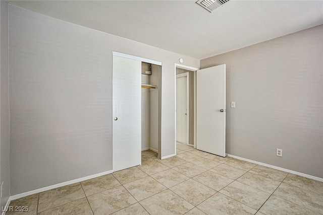 3596 Bronco Rd, Las Vegas, NV 89103 - unfurnished bedroom featuring light tile patterned floors, a closet, and baseboards
