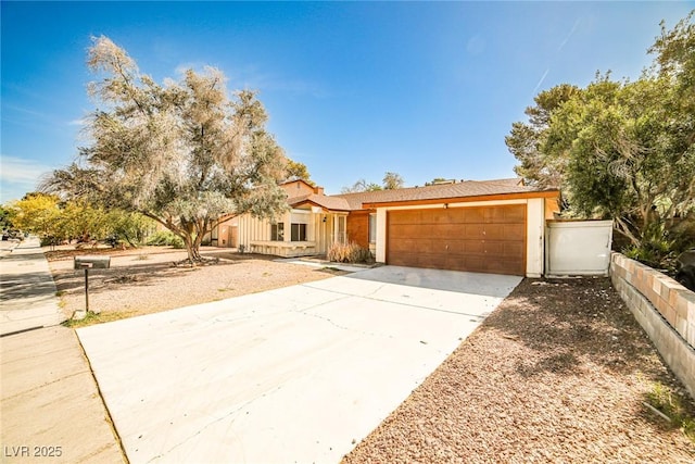 3596 Bronco Rd, Las Vegas, NV 89103 - view of front facade featuring an attached garage, driveway, and stucco siding