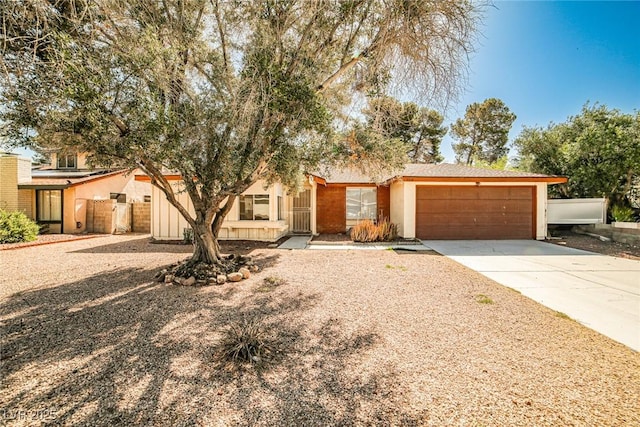 3596 Bronco Rd, Las Vegas, NV 89103 - mid-century home featuring concrete driveway, an attached garage, and stucco siding