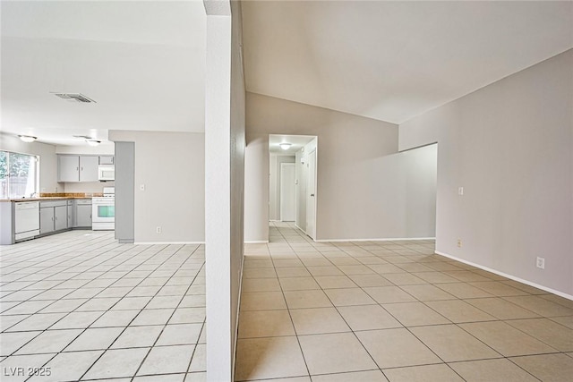 3596 Bronco Rd, Las Vegas, NV 89103 - unfurnished living room featuring light tile patterned flooring, baseboards, and vaulted ceiling