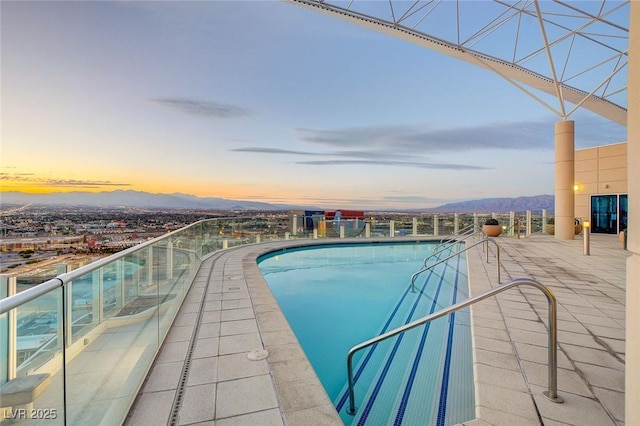 200 Hoover Ave Unit 1905, Las Vegas, NV 89101 - pool at dusk featuring a mountain view and a community pool