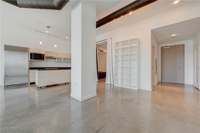 200 Hoover Ave Unit 1905, Las Vegas, NV 89101 - unfurnished living room featuring concrete floors, baseboards, and a high ceiling