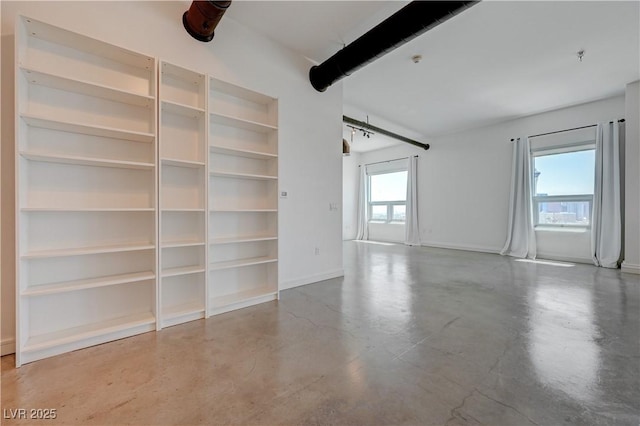 200 Hoover Ave Unit 1905, Las Vegas, NV 89101 - spare room with concrete flooring, baseboards, built in features, and a pendent fire sprinkler