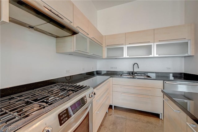 200 Hoover Ave Unit 1905, Las Vegas, NV 89101 - kitchen with stainless steel gas stove, a sink, under cabinet range hood, glass insert cabinets, and a warming drawer
