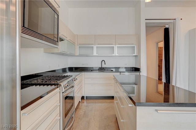 200 Hoover Ave Unit 1905, Las Vegas, NV 89101 - kitchen with stainless steel appliances, a sink, a kitchen island, modern cabinets, and glass insert cabinets