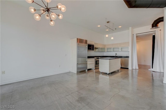 200 Hoover Ave Unit 1905, Las Vegas, NV 89101 - kitchen featuring appliances with stainless steel finishes, dark countertops, finished concrete flooring, a center island, and open floor plan