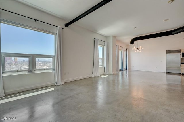 200 Hoover Ave Unit 1905, Las Vegas, NV 89101 - unfurnished room with a chandelier, finished concrete flooring, and baseboards
