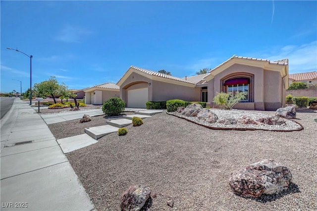 2805 Hanging Rock Dr, Las Vegas, NV 89134 - mediterranean / spanish-style home with stucco siding, a garage, and a tiled roof