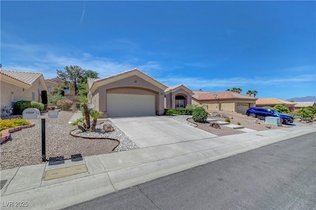2805 Hanging Rock Dr, Las Vegas, NV 89134 - view of front of home with a garage, driveway, stucco siding, and a tiled roof