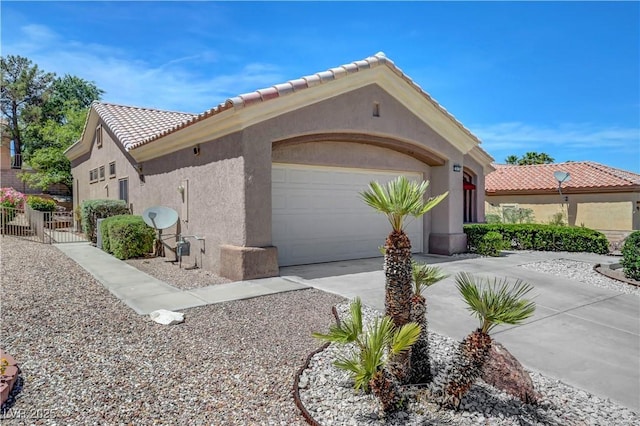 2805 Hanging Rock Dr, Las Vegas, NV 89134 - view of home's exterior with driveway, an attached garage, stucco siding, and a tiled roof