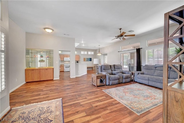 2805 Hanging Rock Dr, Las Vegas, NV 89134 - living room with wood finished floors, ceiling fan, healthy amount of natural light, and baseboards