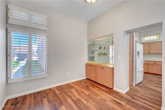 2805 Hanging Rock Dr, Las Vegas, NV 89134 - bar area featuring white refrigerator with ice dispenser, wood finished floors, and baseboards