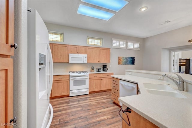 2805 Hanging Rock Dr, Las Vegas, NV 89134 - kitchen with white appliances, a sink, light wood-style floors, plenty of natural light, and recessed lighting