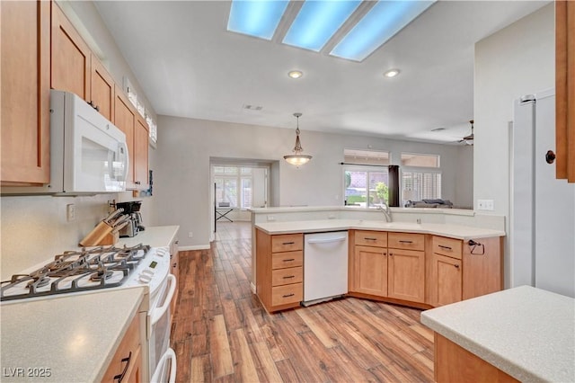 2805 Hanging Rock Dr, Las Vegas, NV 89134 - kitchen featuring white appliances, light wood-type flooring, light countertops, recessed lighting, and a peninsula