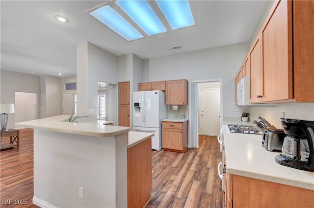 2805 Hanging Rock Dr, Las Vegas, NV 89134 - kitchen with white appliances, light wood-style flooring, light countertops, recessed lighting, and a peninsula