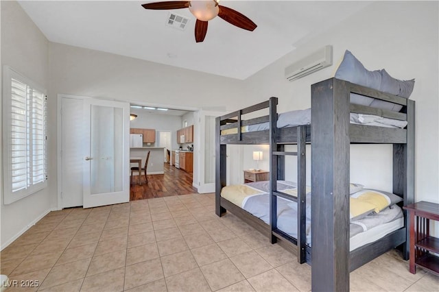2805 Hanging Rock Dr, Las Vegas, NV 89134 - bedroom with a wall unit AC, fridge, light tile patterned floors, a ceiling fan, and baseboards