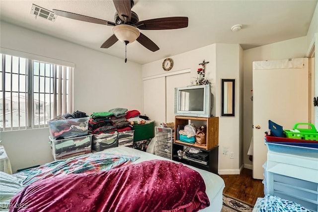 4832 Englewood Ave, Las Vegas, NV 89139 - bedroom with wood finished floors, baseboards, ceiling fan, and a closet