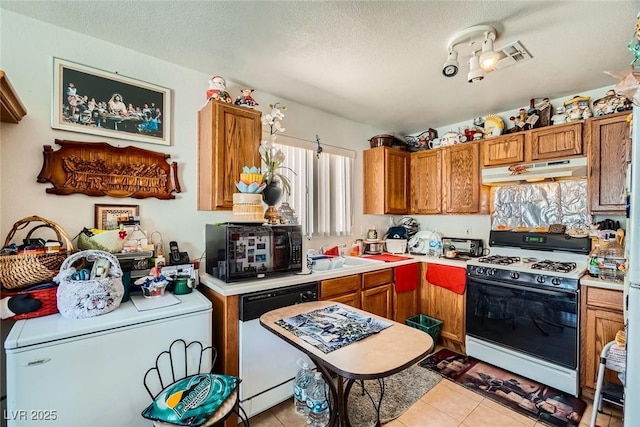 4832 Englewood Ave, Las Vegas, NV 89139 - kitchen featuring gas range, washer / clothes dryer, dishwasher, under cabinet range hood, and black microwave