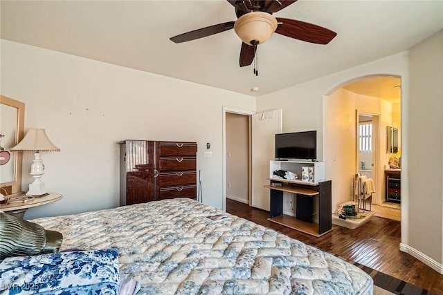 4832 Englewood Ave, Las Vegas, NV 89139 - bedroom featuring arched walkways, wood finished floors, and a ceiling fan