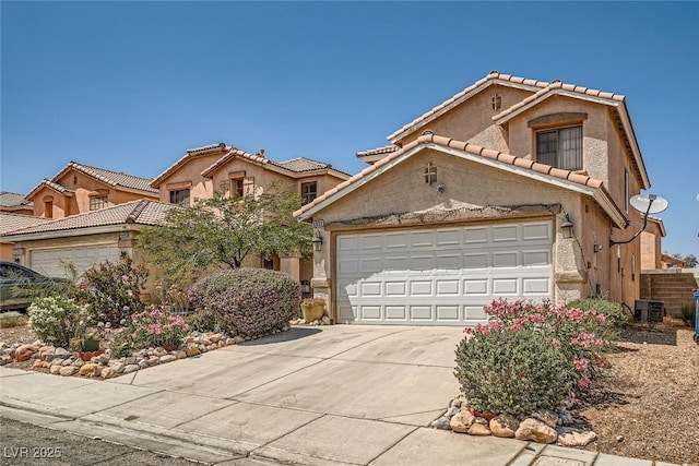 4832 Englewood Ave, Las Vegas, NV 89139 - mediterranean / spanish house with concrete driveway, central AC unit, a garage, a tiled roof, and stucco siding