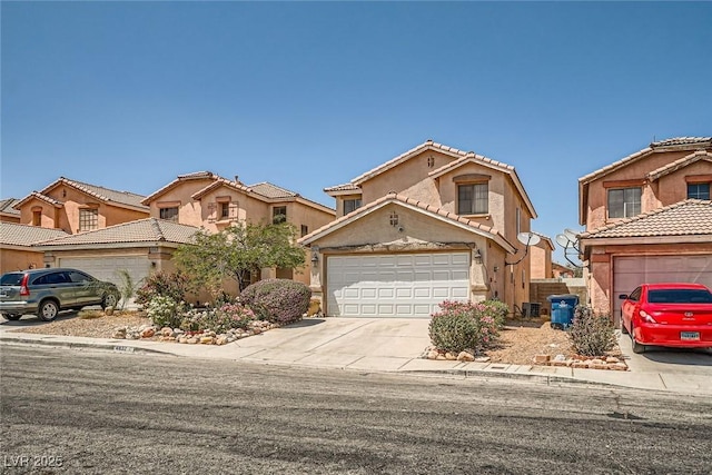 4832 Englewood Ave, Las Vegas, NV 89139 - view of front facade featuring concrete driveway, stucco siding, a tiled roof, and an attached garage