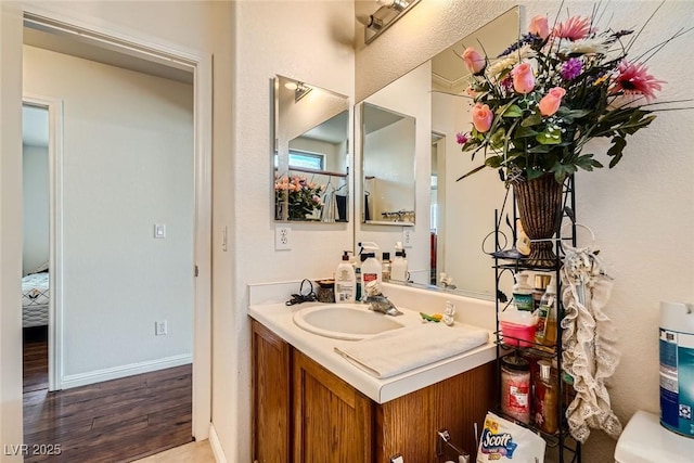 4832 Englewood Ave, Las Vegas, NV 89139 - bathroom with vanity, wood finished floors, and baseboards
