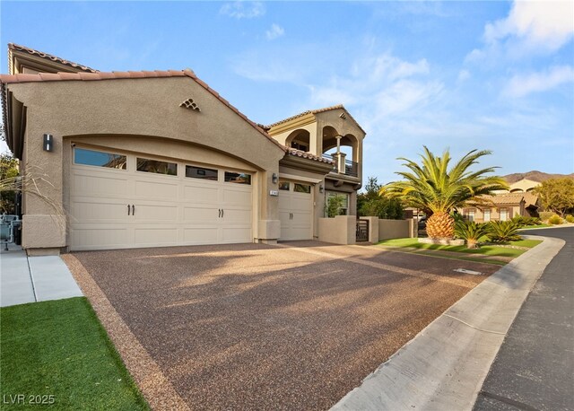 2240 Boutique Ave, Henderson, NV 89044 - mediterranean / spanish-style house with stucco siding, a balcony, a tiled roof, and driveway