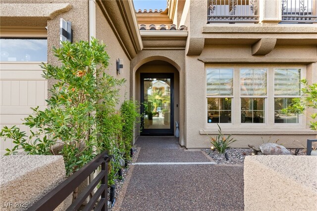 2240 Boutique Ave, Henderson, NV 89044 - property entrance featuring a balcony, stucco siding, and a tile roof