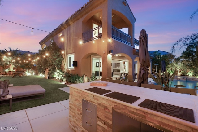 2240 Boutique Ave, Henderson, NV 89044 - back of property with a balcony, a patio area, and stucco siding