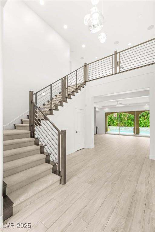 2240 Boutique Ave, Henderson, NV 89044 - staircase with a high ceiling, wood finished floors, and recessed lighting