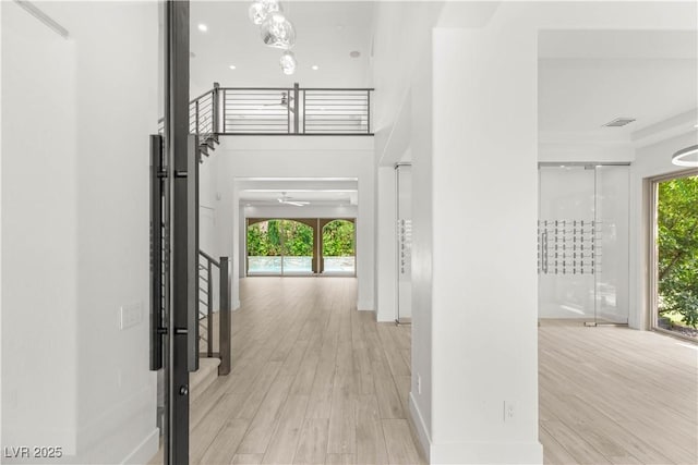 2240 Boutique Ave, Henderson, NV 89044 - hallway with wood finished floors, stairway, and baseboards