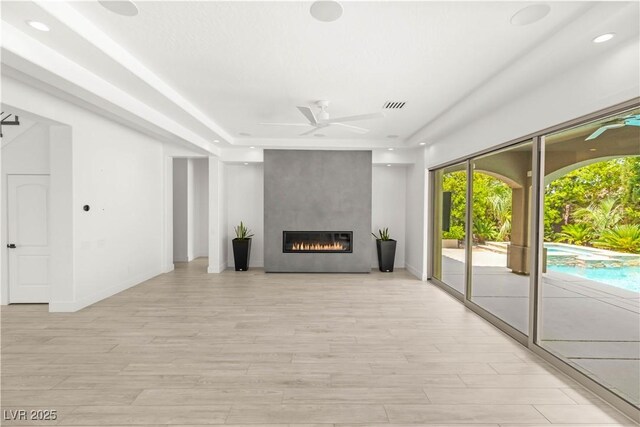 2240 Boutique Ave, Henderson, NV 89044 - unfurnished living room featuring ceiling fan, light wood-type flooring, a large fireplace, baseboards, and recessed lighting