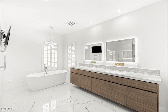 2240 Boutique Ave, Henderson, NV 89044 - full bath featuring marble tiled flooring, double vanity, a freestanding bath, and recessed lighting