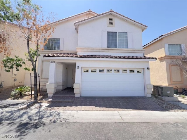 7371 Catmint St, Las Vegas, NV 89113 - mediterranean / spanish home with a garage, stucco siding, a tiled roof, driveway, and central AC unit