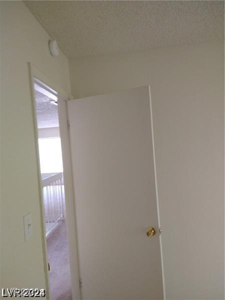 4760 Woodridge Rd, Las Vegas, NV 89121 - corridor with a textured ceiling