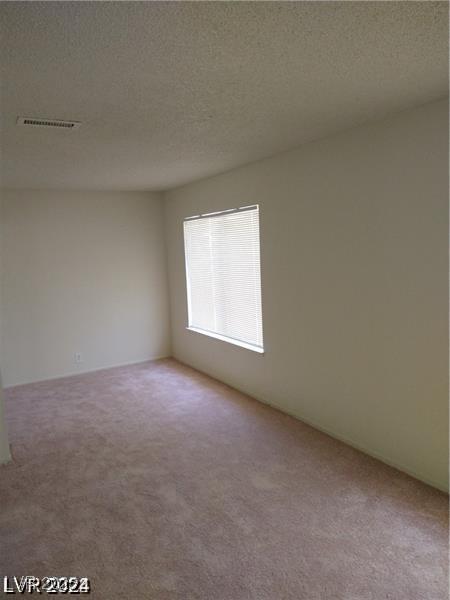 4760 Woodridge Rd, Las Vegas, NV 89121 - unfurnished room with carpet floors and a textured ceiling