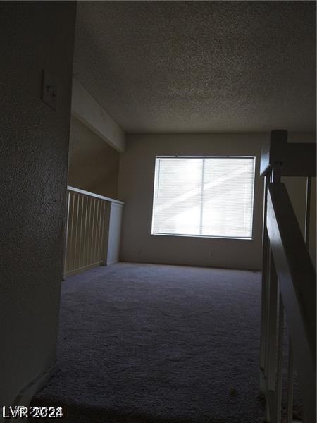 4760 Woodridge Rd, Las Vegas, NV 89121 - carpeted empty room featuring a textured ceiling