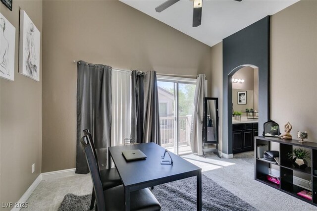 5509 Ante Up Ct Unit 102, Las Vegas, NV 89122 - home office featuring light carpet, arched walkways, a ceiling fan, high vaulted ceiling, and baseboards