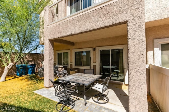 5509 Ante Up Ct Unit 102, Las Vegas, NV 89122 - fenced backyard with a patio area, outdoor dining area, and a balcony