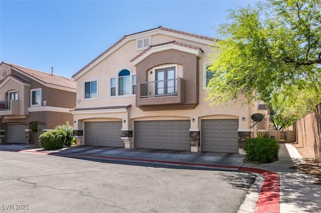 5509 Ante Up Ct Unit 102, Las Vegas, NV 89122 - multi unit property with stucco siding, a balcony, a garage, stone siding, and driveway