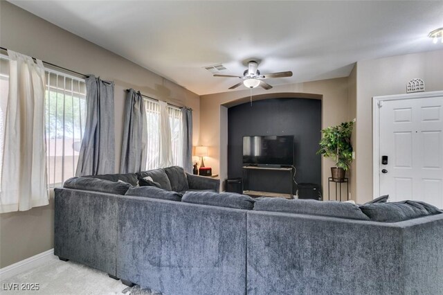 5509 Ante Up Ct Unit 102, Las Vegas, NV 89122 - living area featuring a ceiling fan, baseboards, plenty of natural light, and light colored carpet