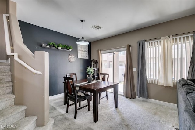 5509 Ante Up Ct Unit 102, Las Vegas, NV 89122 - dining room featuring carpet flooring, stairway, and baseboards